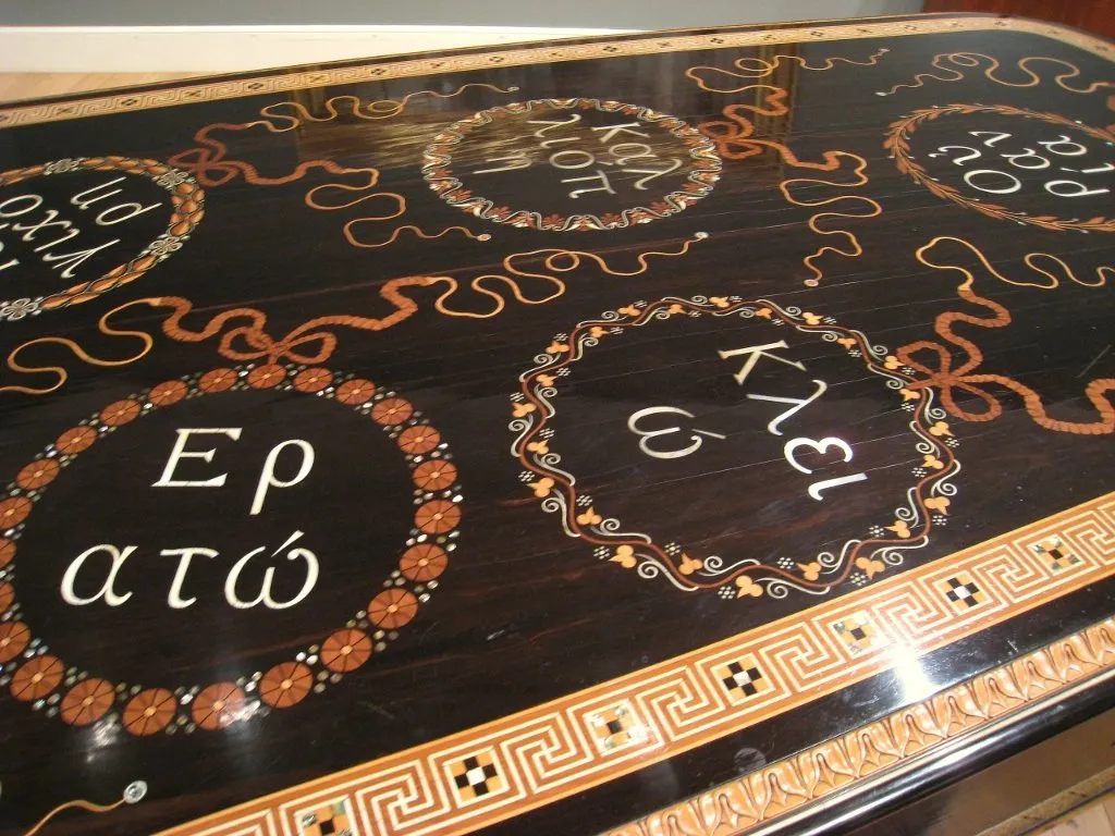 Intricate boxwood and mother-of-pearl inlay of Muses on the Alma Tadema Steinway lid